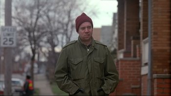 Movie still from “American Splendor” (2003), directed by Shari Springer Berman – A man wearing a red hat and a green jacket; Medium shot, Over the shoulder angle
