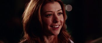 Movie still from “American Wedding” (2003), directed by Jesse Dylan – A woman smiling for the camera; Close Up shot, Over the shoulder angle