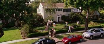 Movie still from “American Wedding” (2003), directed by Jesse Dylan – A group of people walking down a sidewalk with balloons; Extreme Wide shot, High angle