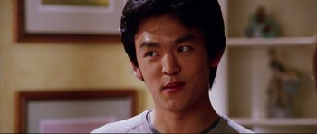 Movie still from “American Wedding” (2003), directed by Jesse Dylan – A person wearing a gray t - shirt; Close Up shot, Over the shoulder angle