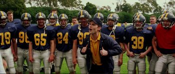 Movie still from “American Wedding” (2003), directed by Jesse Dylan – A group of football players standing next to each other on a field; Medium shot, Low angle