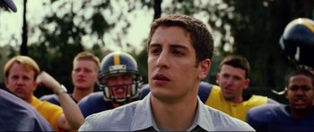 Movie still from “American Wedding” (2003), directed by Jesse Dylan – A football player is standing in front of a group of other players; Close Up shot, Over the shoulder angle