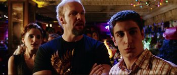 Movie still from “American Wedding” (2003), directed by Jesse Dylan – A man and a boy standing next to each other in a room; Medium shot, Over the shoulder angle