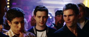 Movie still from “American Wedding” (2003), directed by Jesse Dylan – A group of men standing next to each other in a room; Close Up shot, Over the shoulder angle