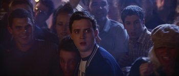 Movie still from “American Wedding” (2003), directed by Jesse Dylan – A group of young people in a room; Medium shot, Over the shoulder angle