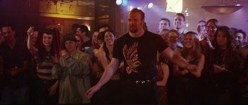 Movie still from “American Wedding” (2003), directed by Jesse Dylan – A group of people in a room with a crowd; Medium shot, Low angle