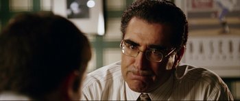 Movie still from “American Wedding” (2003), directed by Jesse Dylan – A person wearing a suit and glasses; Close Up shot, Over the shoulder angle