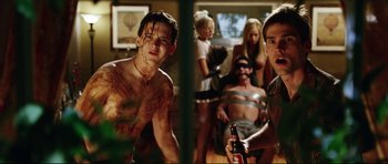 Movie still from “American Wedding” (2003), directed by Jesse Dylan – A group of people in a room with a bottle of beer; Medium shot, Low angle