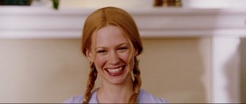 Movie still from “American Wedding” (2003), directed by Jesse Dylan – A woman with red hair smiling for the camera; Close Up shot, Low angle