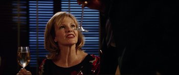 Movie still from “American Wedding” (2003), directed by Jesse Dylan – A woman in a black dress is smiling at a man in a black suit; Close Up shot, Over the shoulder angle