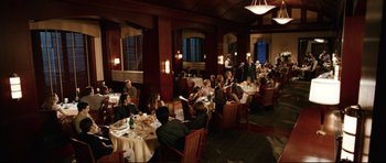 Movie still from “American Wedding” (2003), directed by Jesse Dylan – A group of people sitting at tables in a restaurant; Extreme Wide shot, High angle