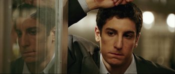 Movie still from “American Wedding” (2003), directed by Jesse Dylan – A person looking at his reflection in a mirror; Close Up shot, Low angle