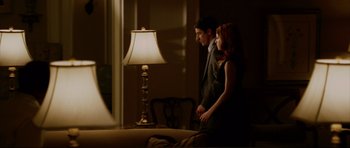 Movie still from “American Wedding” (2003), directed by Jesse Dylan – A man and a woman standing in front of a table lamp; Medium shot, Low angle