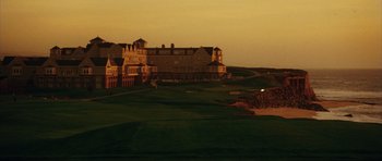 Movie still from “American Wedding” (2003), directed by Jesse Dylan – A view of a golf course with a large building in the background; Extreme Wide shot, Low angle