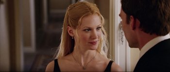 Movie still from “American Wedding” (2003), directed by Jesse Dylan – A woman with long blonde hair wearing a black top; Close Up shot, Over the shoulder angle