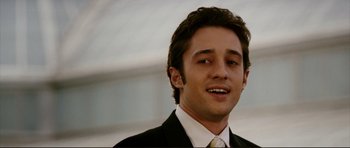 Movie still from “American Wedding” (2003), directed by Jesse Dylan – A man in a suit and tie smiling for the camera; Close Up shot, Low angle