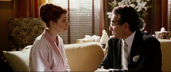 Movie still from “American Wedding” (2003), directed by Jesse Dylan – A man and a woman sitting in a living room talking to each other; Medium shot, Over the shoulder angle