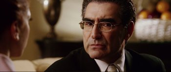 Movie still from “American Wedding” (2003), directed by Jesse Dylan – A man in a suit and tie looking at the camera; Close Up shot, Over the shoulder angle