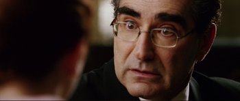 Movie still from “American Wedding” (2003), directed by Jesse Dylan – A person wearing glasses and a black shirt; Close Up shot, Over the shoulder angle