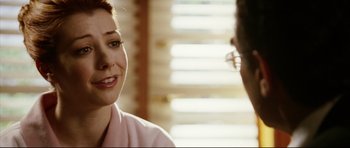 Movie still from “American Wedding” (2003), directed by Jesse Dylan – A woman in a pink robe talking to another woman; Close Up shot, Over the shoulder angle