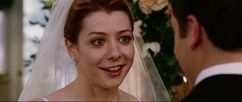 Movie still from “American Wedding” (2003), directed by Jesse Dylan – A person wearing a wedding dress; Close Up shot, Over the shoulder angle