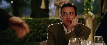 Movie still from “American Wedding” (2003), directed by Jesse Dylan – A person sitting at a table with a glass of wine; Close Up shot, Low angle