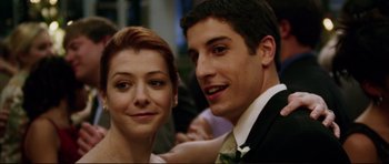 Movie still from “American Wedding” (2003), directed by Jesse Dylan – A man and a woman posing for a picture; Close Up shot, Low angle