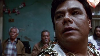 Movie still from “Amores Perros” (2000), directed by Alejandro G. Iñárritu – A man's face in a room with other people; Close Up shot, Low angle