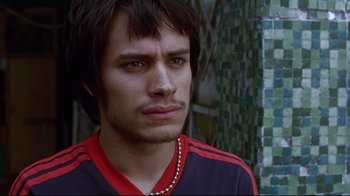 Movie still from “Amores Perros” (2000), directed by Alejandro G. Iñárritu – A person wearing a shirt; Close Up shot, High angle