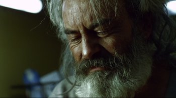 Movie still from “Amores Perros” (2000), directed by Alejandro G. Iñárritu – An old man with long white hair and a beard; Close Up shot, Low angle
