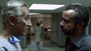 Movie still from “Amores Perros” (2000), directed by Alejandro G. Iñárritu – Two men are facing each other in an office; Close Up shot, Over the shoulder angle
