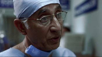 Movie still from “Amores Perros” (2000), directed by Alejandro G. Iñárritu – An older man wearing glasses and a surgical cap; Close Up shot, Low angle