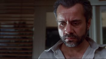 Movie still from “Amores Perros” (2000), directed by Alejandro G. Iñárritu – A person wearing a white shirt; Close Up shot, Low angle