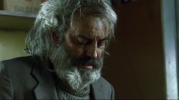 Movie still from “Amores Perros” (2000), directed by Alejandro G. Iñárritu – An older man with a beard and a jacket; Close Up shot, Low angle