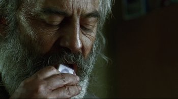 Movie still from “Amores Perros” (2000), directed by Alejandro G. Iñárritu – An old man with a beard is holding a toothbrush; Extreme Close Up shot, Overhead angle