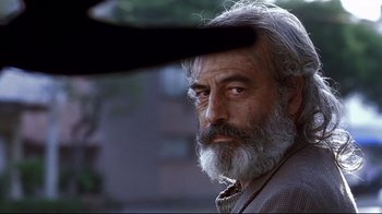 Movie still from “Amores Perros” (2000), directed by Alejandro G. Iñárritu – An older man with a beard looking into the distance; Close Up shot, Low angle