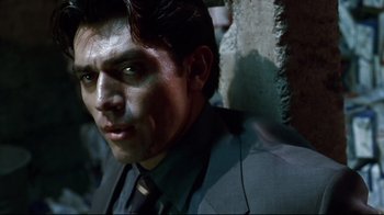 Movie still from “Amores Perros” (2000), directed by Alejandro G. Iñárritu – A person wearing a suit and tie; Close Up shot, Low angle