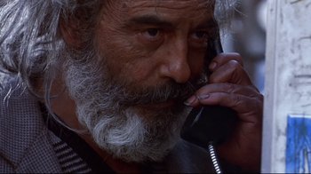 Movie still from “Amores Perros” (2000), directed by Alejandro G. Iñárritu – An old man with a beard talking on a phone; Close Up shot, Low angle