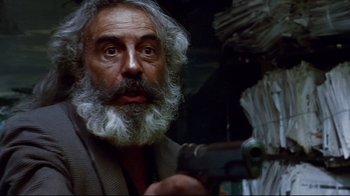 Movie still from “Amores Perros” (2000), directed by Alejandro G. Iñárritu – An old man with a beard holding a gun in his hand; Close Up shot, Low angle
