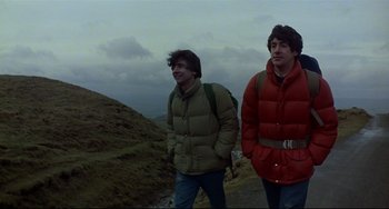 Movie still from “An American Werewolf in London” (1981), directed by John Landis – Two young men standing on top of a hill; Medium shot, Low angle