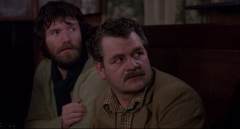 Movie still from “An American Werewolf in London” (1981), directed by John Landis – A man with a beard and mustache and a man with a beard and mustache; Close Up shot, Over the shoulder angle