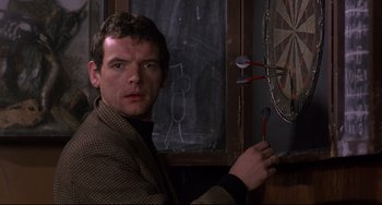 Movie still from “An American Werewolf in London” (1981), directed by John Landis – A man in a jacket is holding two spoons; Close Up shot, Over the shoulder angle