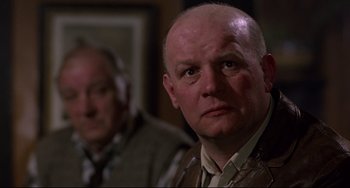 Movie still from “An American Werewolf in London” (1981), directed by John Landis – A man with a shaved head and a bald head; Close Up shot, Low angle