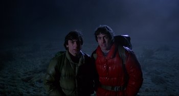 Movie still from “An American Werewolf in London” (1981), directed by John Landis – Two people standing next to each other in the dark; Medium shot, Low angle