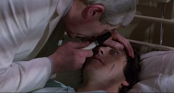Movie still from “An American Werewolf in London” (1981), directed by John Landis – A doctor is examining a young man's eyes; Close Up shot, High angle