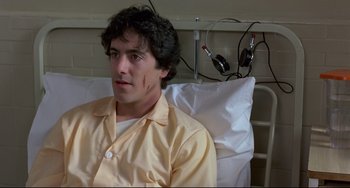 Movie still from “An American Werewolf in London” (1981), directed by John Landis – A man sitting in a hospital bed with a bandage on his face; Close Up shot, High angle