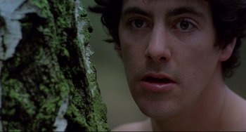 Movie still from “An American Werewolf in London” (1981), directed by John Landis – A man's face next to a tree trunk; Close Up shot, Low angle