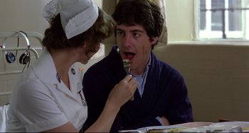 Movie still from “An American Werewolf in London” (1981), directed by John Landis – A man and a woman are eating food together; Close Up shot, Over the shoulder angle