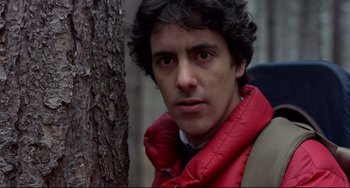 Movie still from “An American Werewolf in London” (1981), directed by John Landis – A person wearing a jacket near a tree; Close Up shot, Low angle