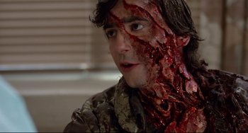 Movie still from “An American Werewolf in London” (1981), directed by John Landis – A young man with blood all over his face; Close Up shot, Over the shoulder angle